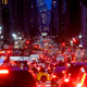 A photo of a busy street in New York at night.